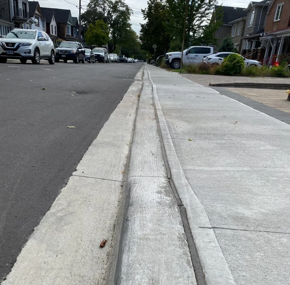 Concrete curb and gutter edging a residential street