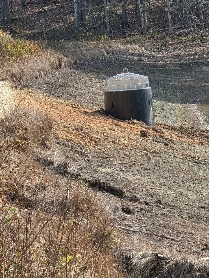 Concrete drainage structure set into a graded bank