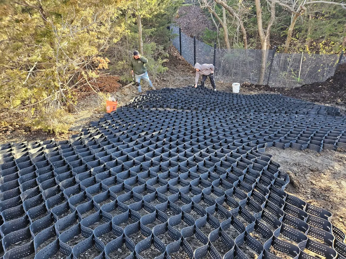 Crew installing a geocell ground grid on a graded slope
