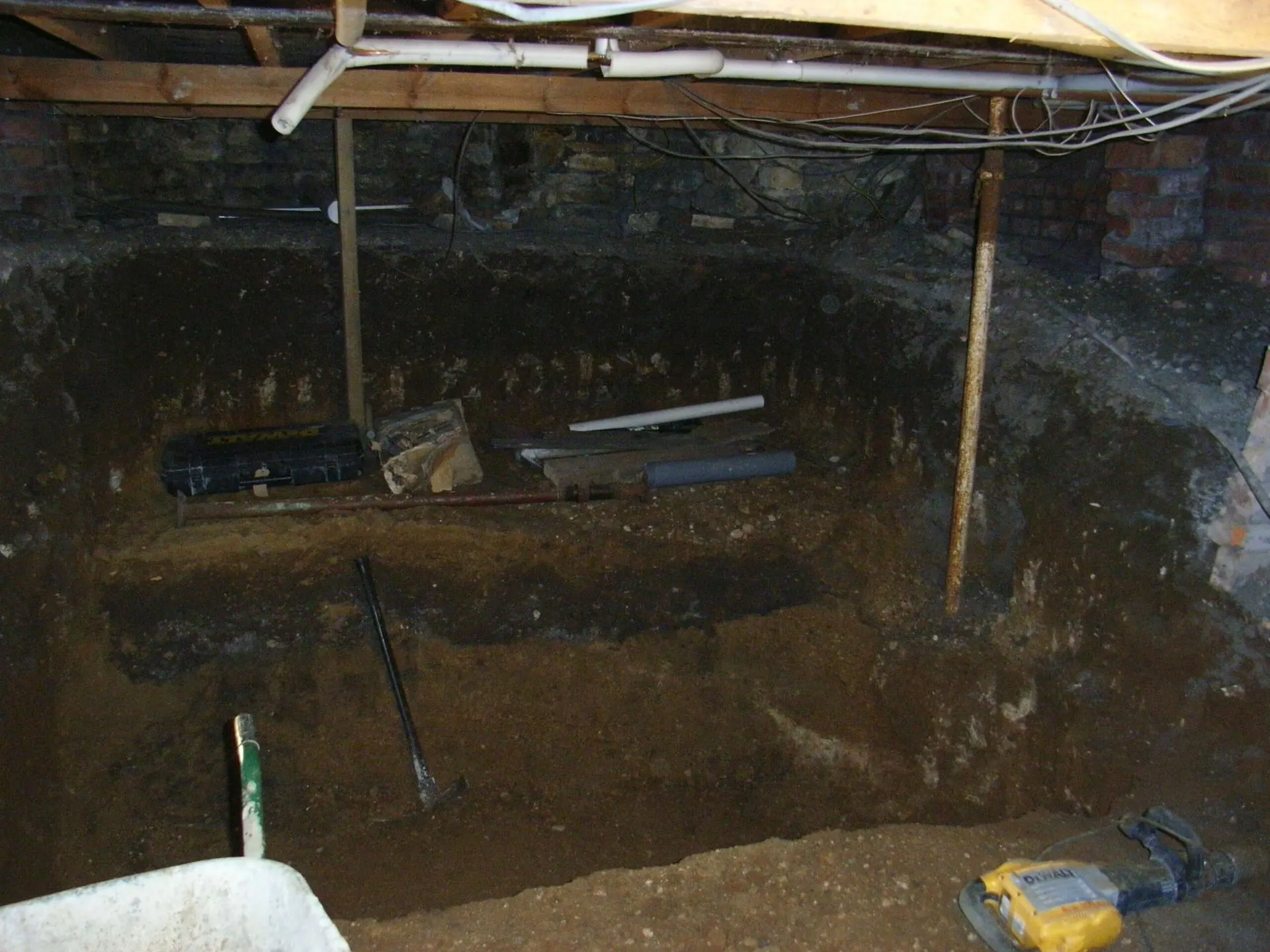 Excavated crawl space beneath an existing house