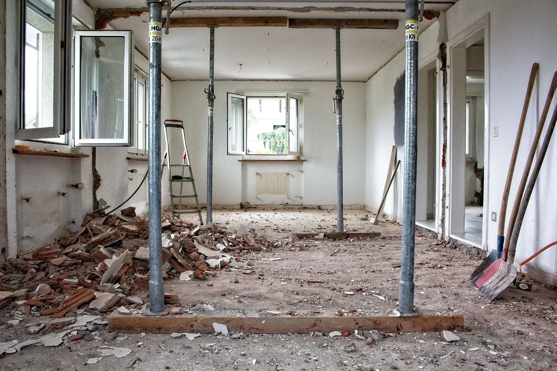 Gutted interior room braced with steel props during demolition