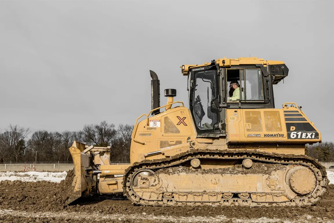 Caterpillar dozer parked on a graded field