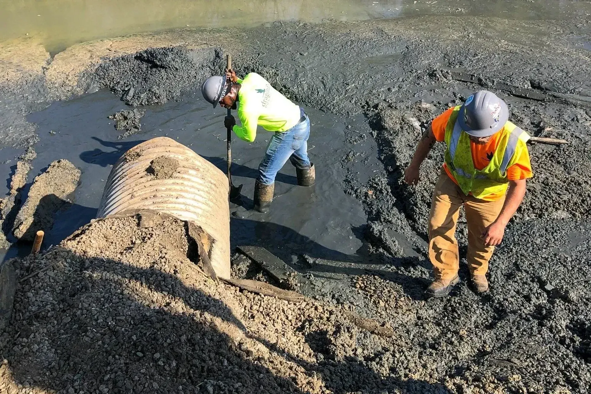 Crew excavating around a failed stormwater culvert pipe